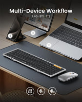 ProtoArc XKM01 unfolded on a desk, next to a laptop and a tablet · ergoliv